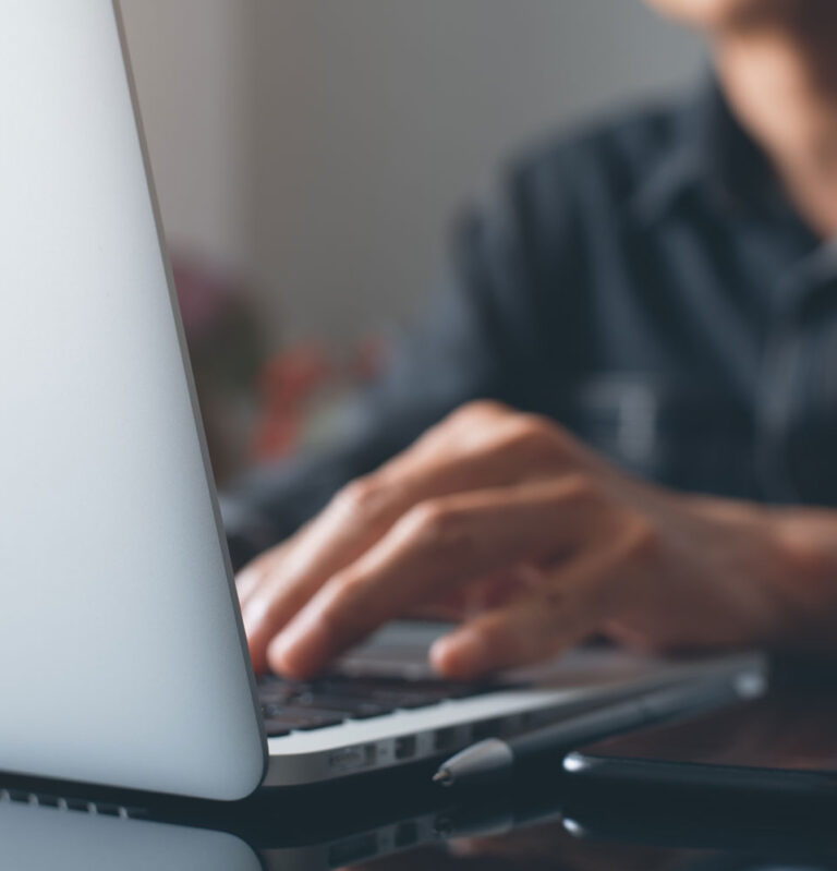 Dental patient using a laptop at J.P Prosthodontics in Fullerton, CA