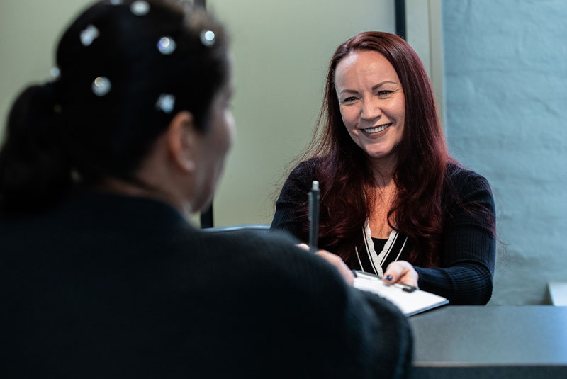 Patient talking with Janel Bryan, Office Manager at J.P Prosthodontics in Fullerton, CA