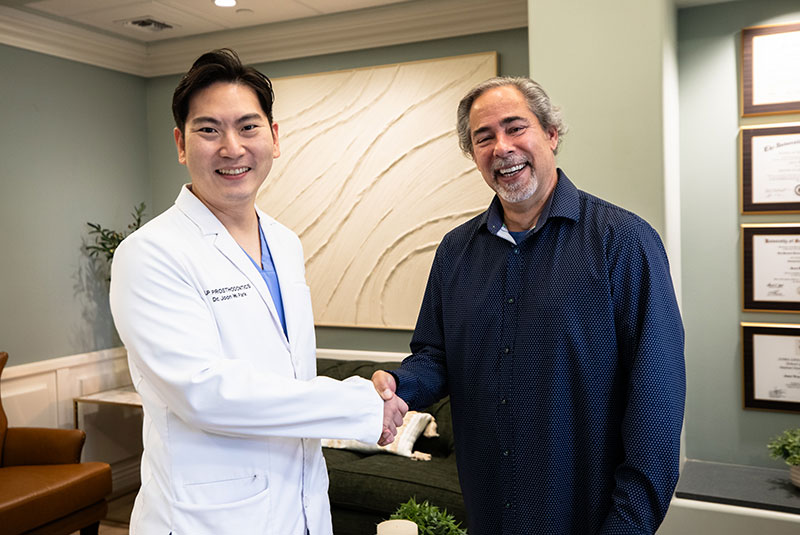 Dr. Joon Park with a smiling patient at J.P Prosthodontics in Fullerton, CA during a dental bridge consultation
